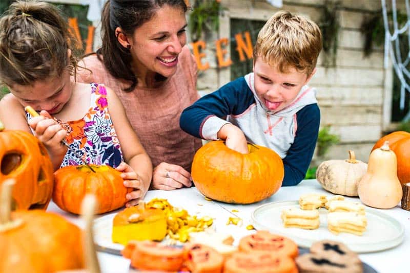 MOther with Children Carving Pumkins